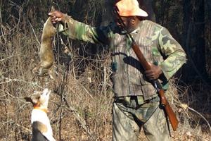 Rabbit hunter and beagle with rabbit