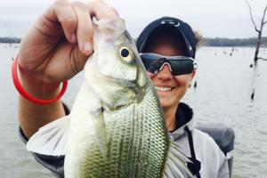 Lady angler at Lake Fort holding up a larg white bass