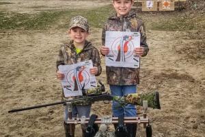 Two young hunters target shooting practice before turkey hunt