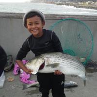 This boy loves fishing striped bass